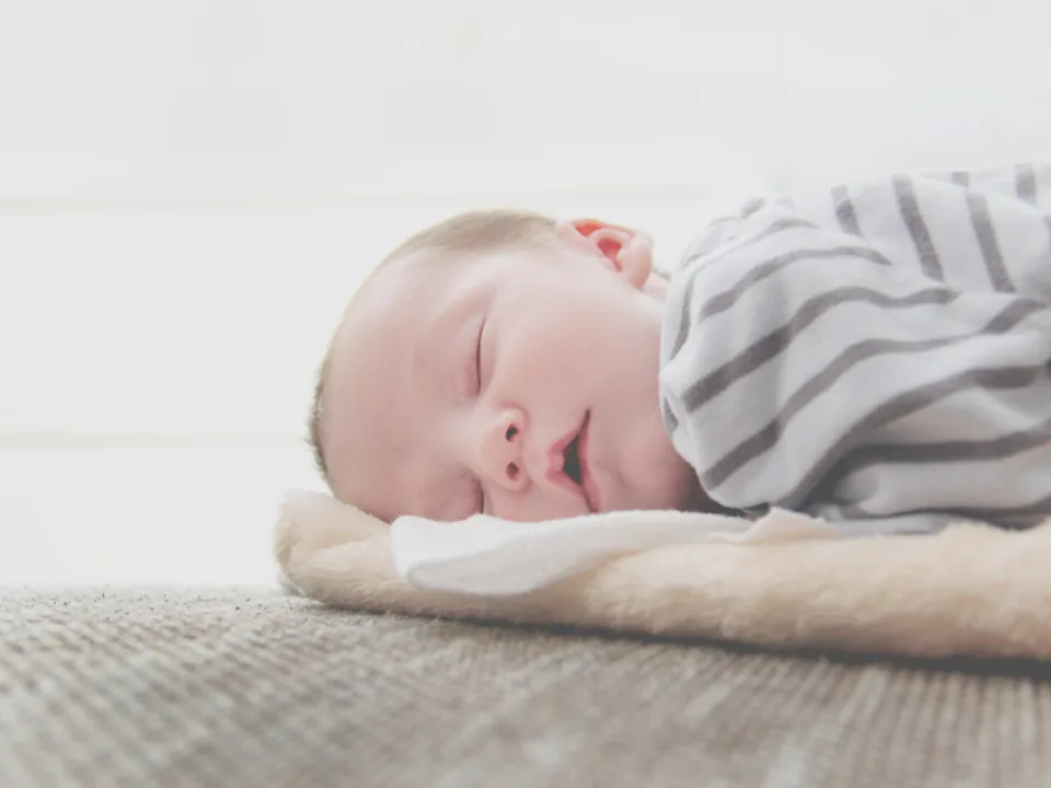 Newborn asleep on a blanket