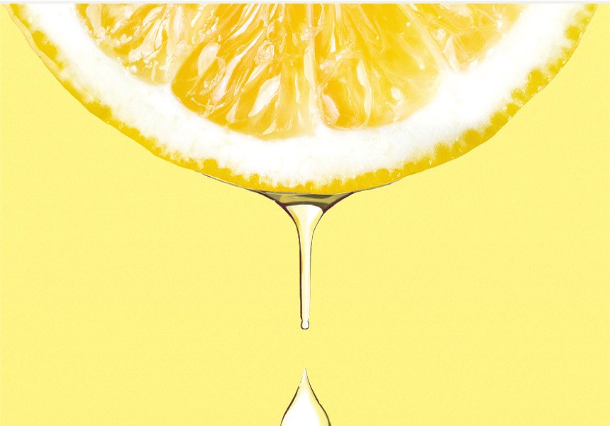 Juice dripping from a fresh lemon slice