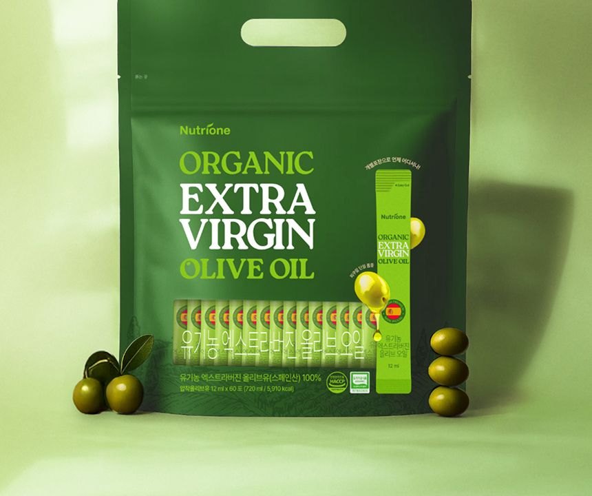 Olive oil pouch standing beside fresh green olives