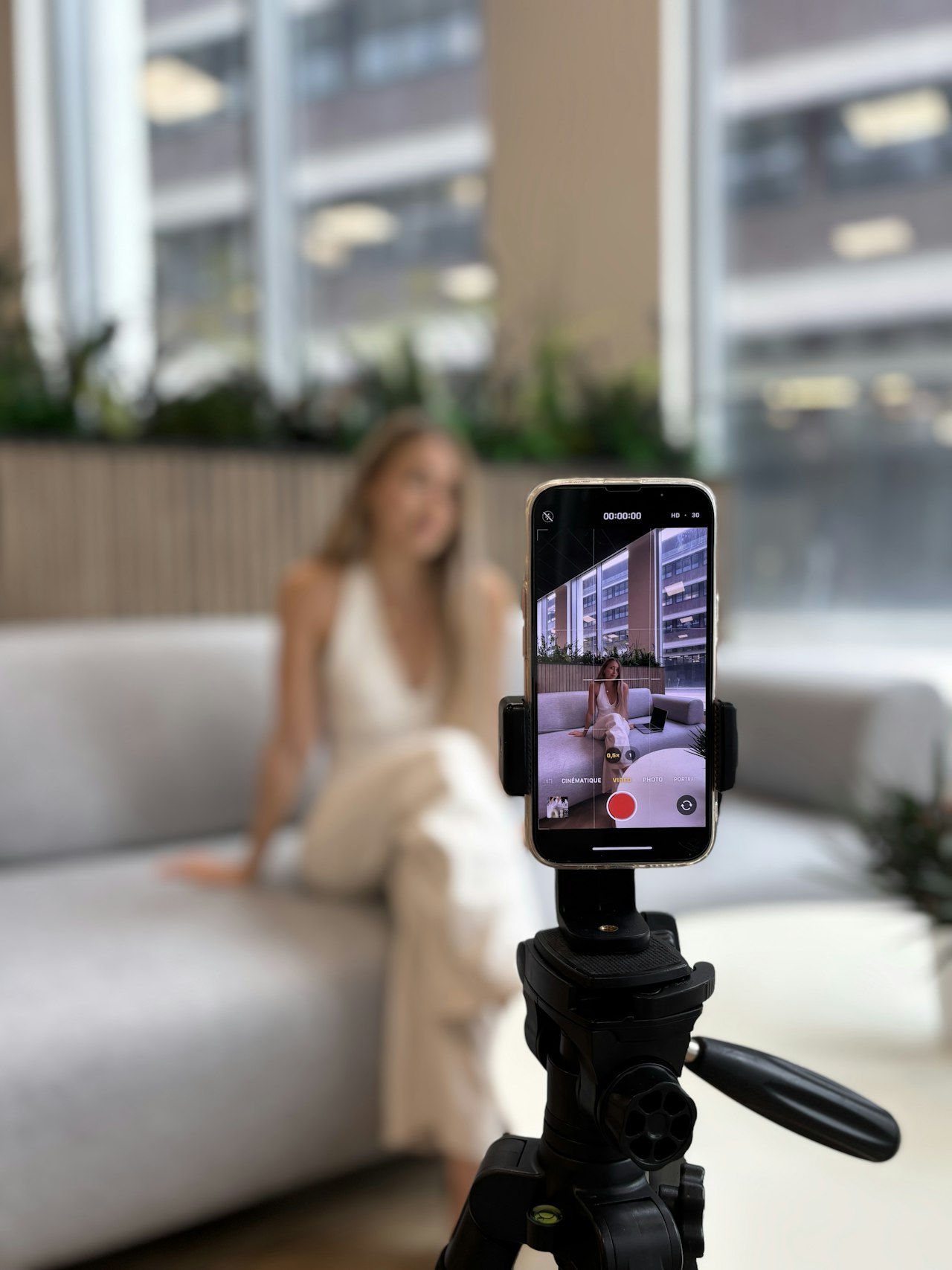 A creator filming a product review video on a phone mounted on a tripod