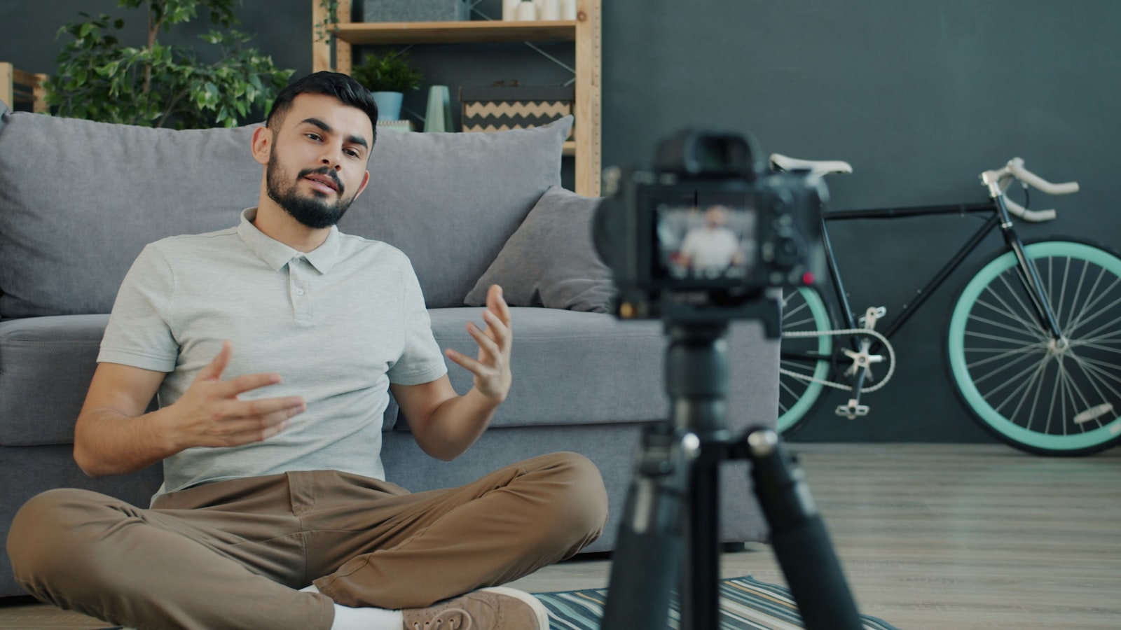 A creator recording a talking-head video for a camera on a tripod