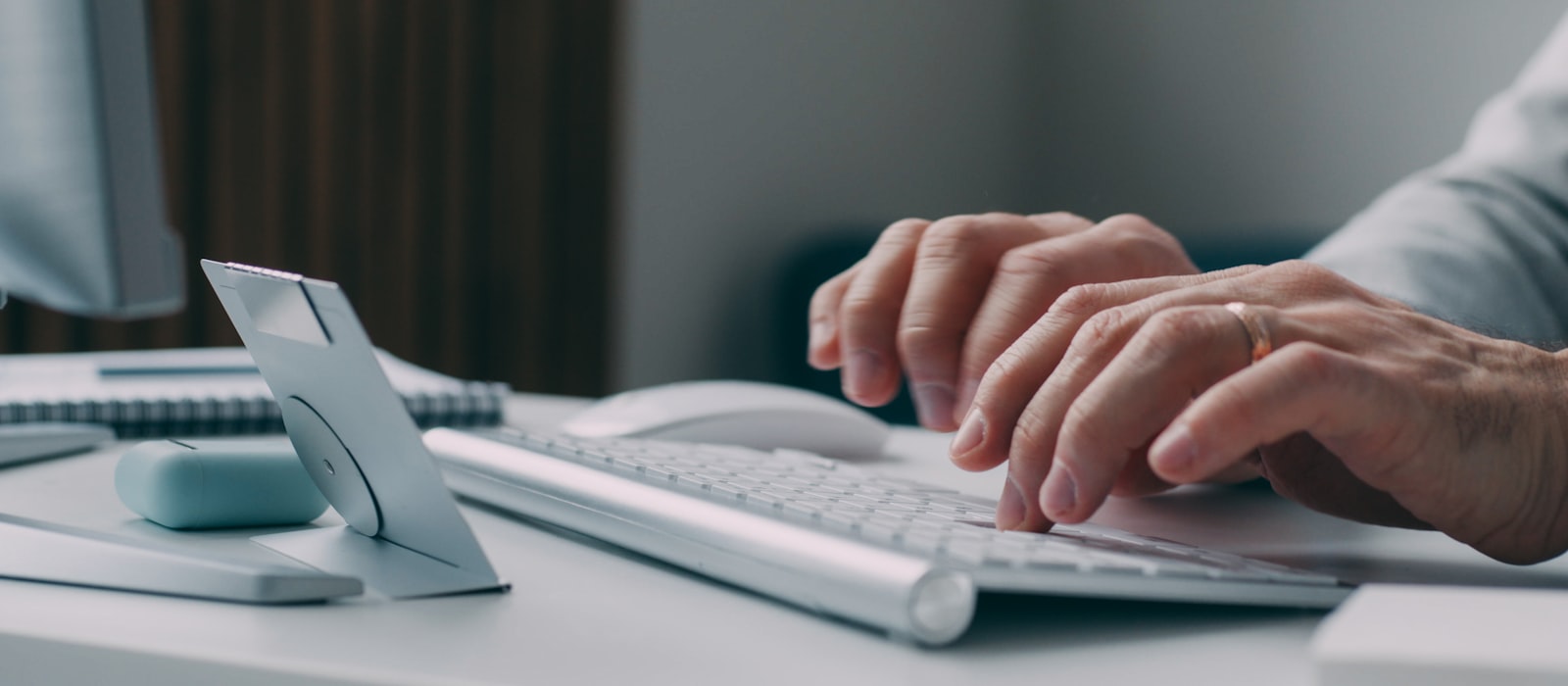 A person typing a pitch message to a brand at a keyboard